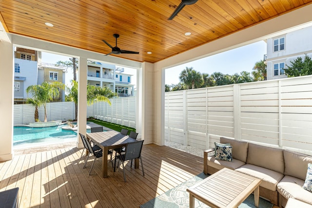 wooden deck featuring ceiling fan, an outdoor hangout area, and a fenced in pool