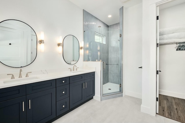 bathroom featuring tile patterned floors, vanity, and a shower with door