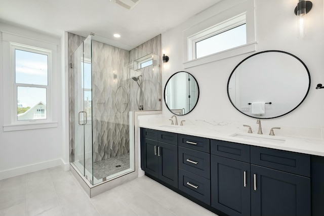 bathroom with tile patterned flooring, vanity, a wealth of natural light, and an enclosed shower