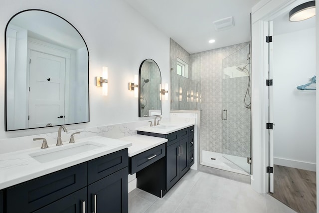 bathroom featuring vanity, an enclosed shower, and tile patterned flooring