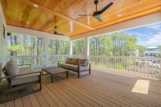 deck with an outdoor living space and ceiling fan