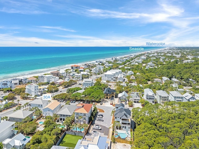 drone / aerial view featuring a water view and a view of the beach