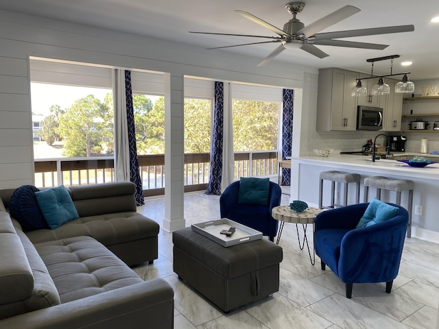 living room with a healthy amount of sunlight and sink