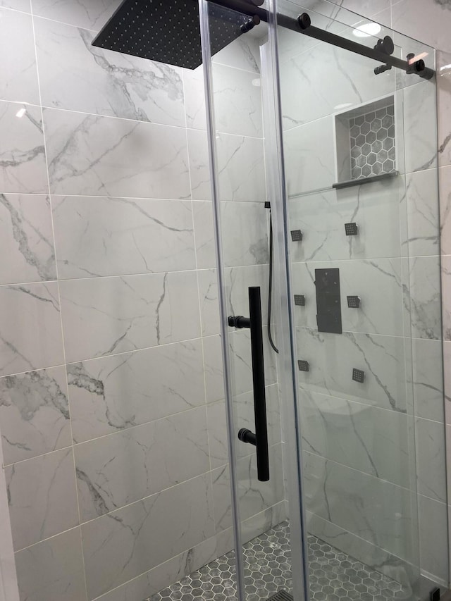 bathroom with a shower with door