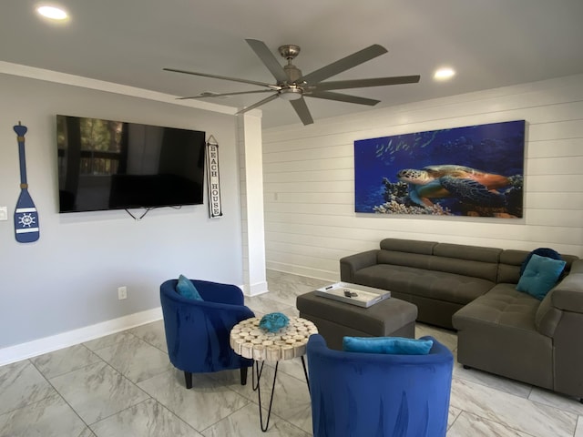 living room featuring ceiling fan, ornamental molding, and wood walls