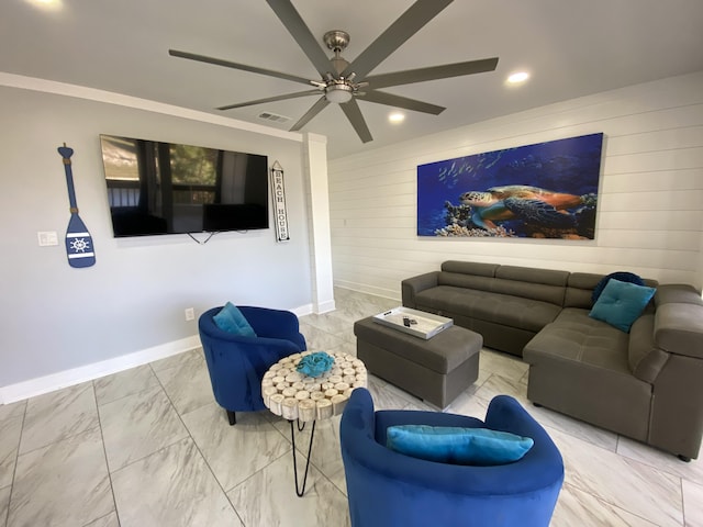 living room with ceiling fan, crown molding, and wooden walls