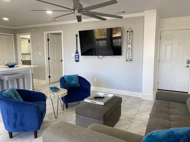 living room with ceiling fan and ornamental molding