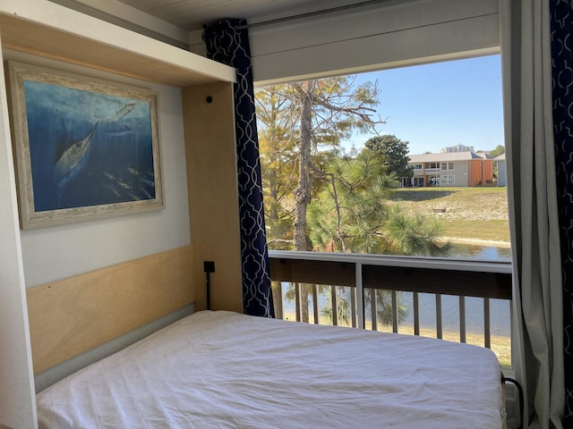 bedroom featuring a water view