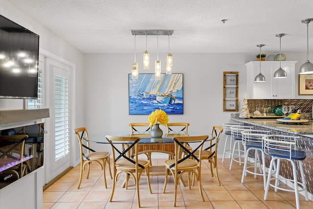144 Spires Ln Unit 114, Santa Rosa Beach, FL 32459 - tiled dining space featuring a textured ceiling