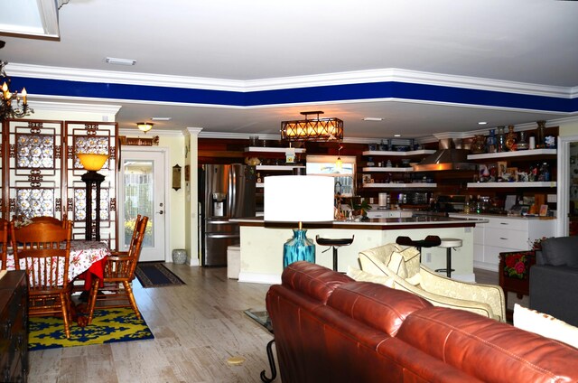501 Benning Dr, Destin, FL 32541 - living room featuring decorative columns, hardwood / wood-style flooring, a chandelier, and ornamental molding