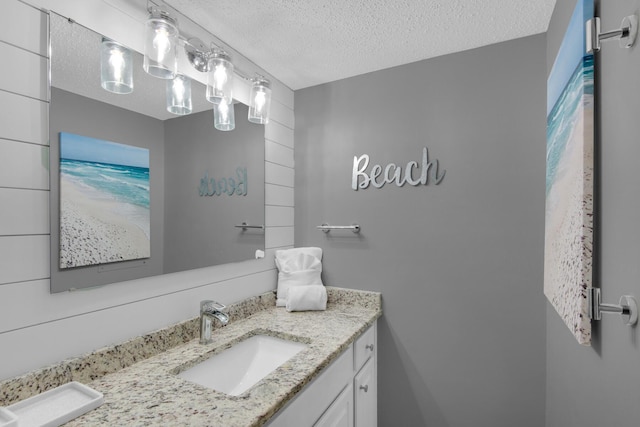 bathroom with a textured ceiling and vanity