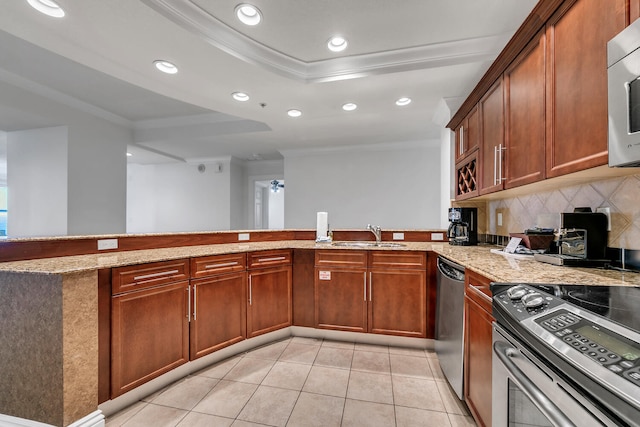 kitchen featuring kitchen peninsula, appliances with stainless steel finishes, crown molding, and light tile patterned flooring