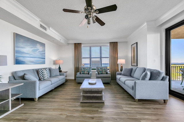 living room featuring a textured ceiling, ceiling fan, crown molding, and hardwood / wood-style floors