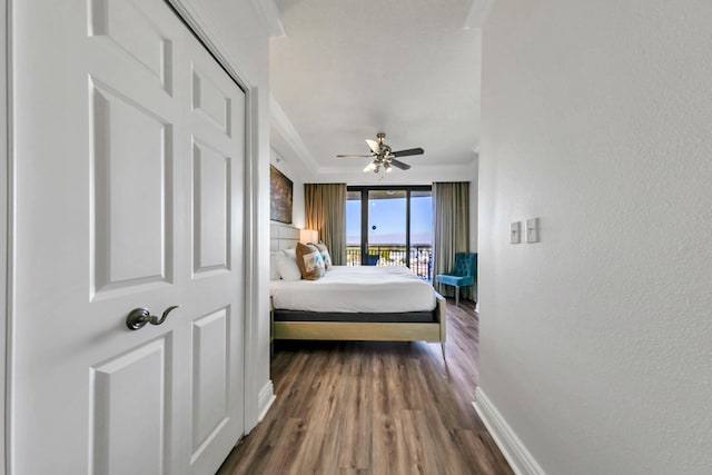 bedroom with ceiling fan, dark hardwood / wood-style flooring, access to exterior, and ornamental molding