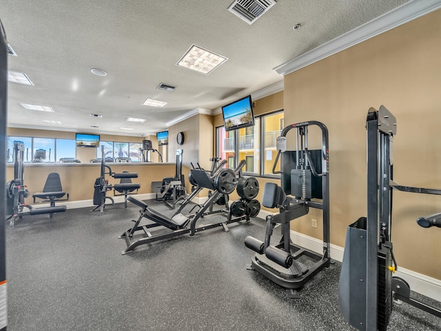 gym with crown molding and a textured ceiling