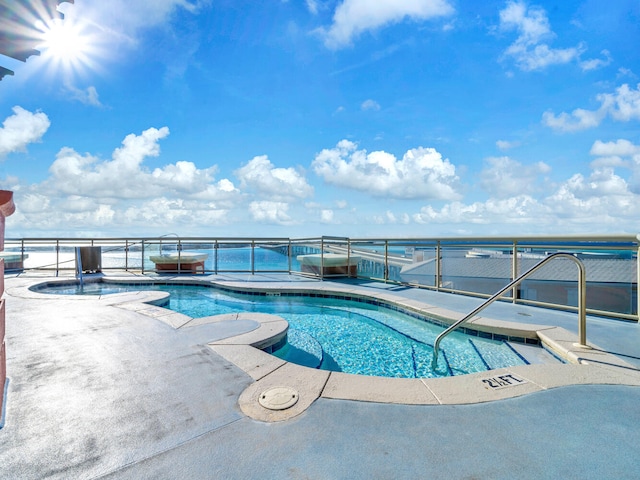 view of pool featuring a water view