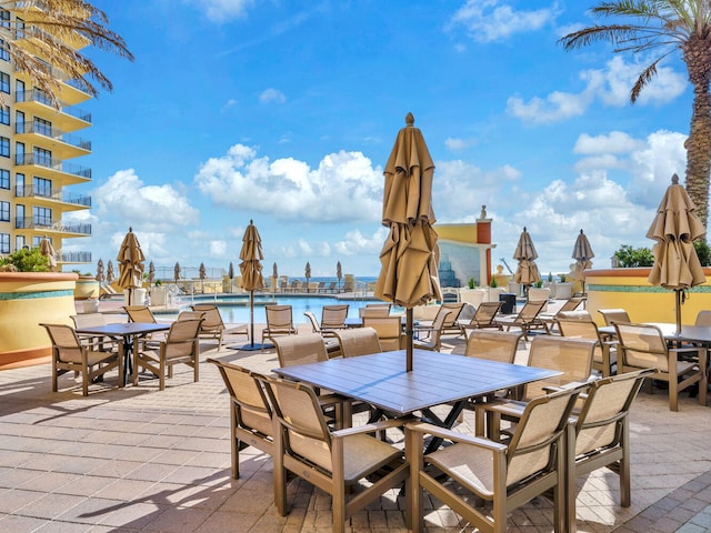 view of patio / terrace with a water view and a community pool