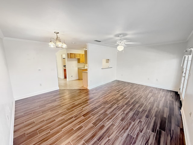 unfurnished living room featuring ornamental molding and ceiling fan with notable chandelier