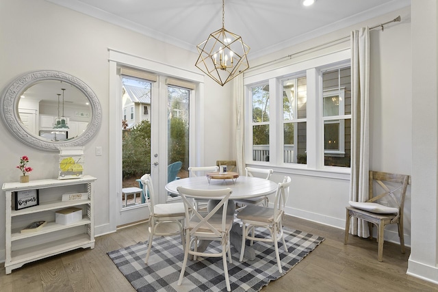 dining room featuring a notable chandelier, dark hardwood / wood-style flooring, crown molding, and french doors