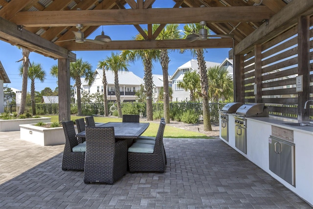 view of patio featuring grilling area, ceiling fan, sink, and an outdoor kitchen