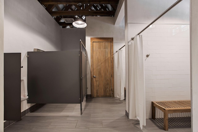 bathroom featuring beamed ceiling