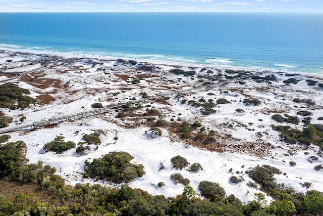 birds eye view of property with a water view and a view of the beach