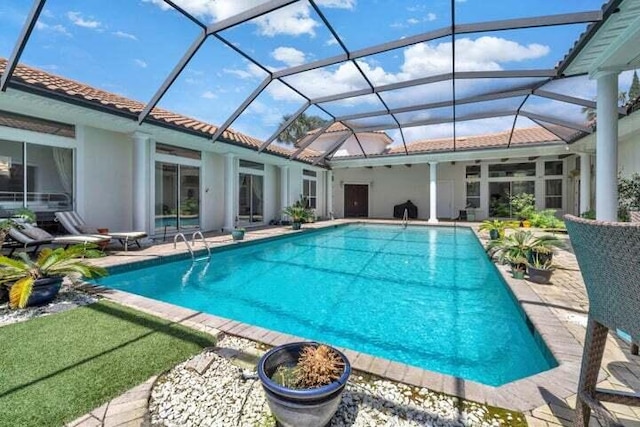 view of pool with a lanai and a patio