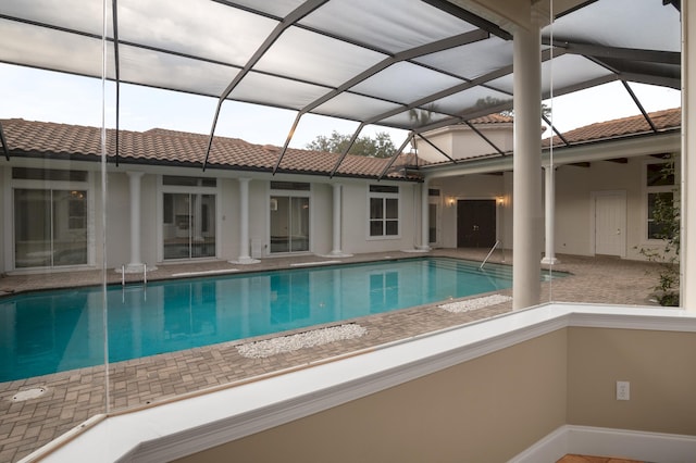 view of swimming pool featuring a lanai