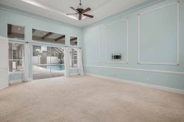 carpeted empty room with beamed ceiling, ceiling fan, and ornamental molding