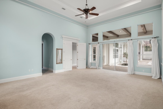 carpeted empty room with beam ceiling, ceiling fan, and a towering ceiling