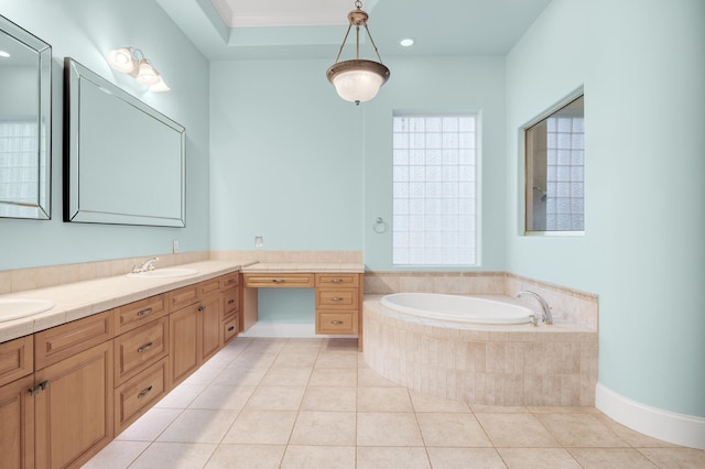 bathroom with crown molding, tile patterned flooring, vanity, and a relaxing tiled tub