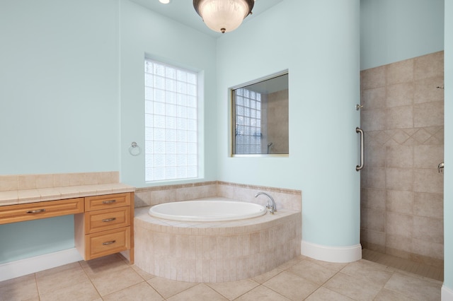 bathroom featuring tile patterned flooring and shower with separate bathtub