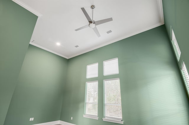 spare room featuring ceiling fan and ornamental molding