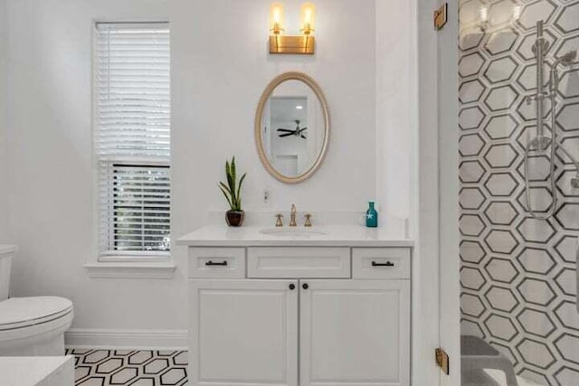 bathroom featuring vanity, toilet, and a shower