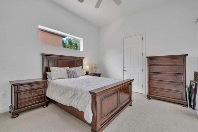 bedroom featuring ceiling fan, lofted ceiling, and light carpet