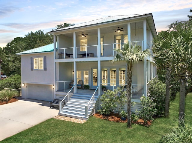 view of front of home with a lawn, a balcony, covered porch, and a garage