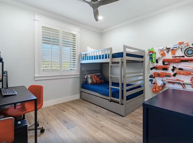 bedroom featuring crown molding, ceiling fan, and light wood-type flooring