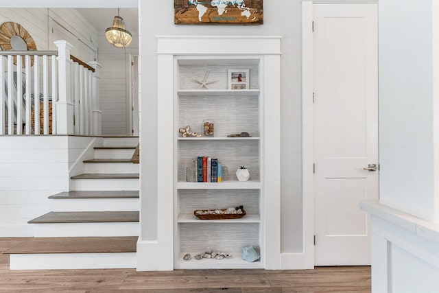 stairway with hardwood / wood-style flooring