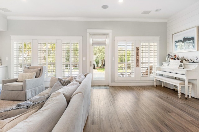 living room with hardwood / wood-style flooring and ornamental molding