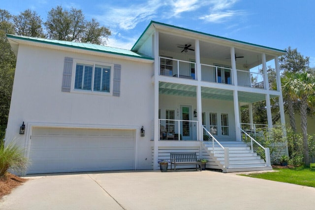 view of front of house with covered porch, a balcony, and a garage