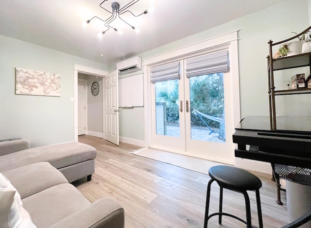 living room with a wall mounted air conditioner, light wood-type flooring, and a chandelier