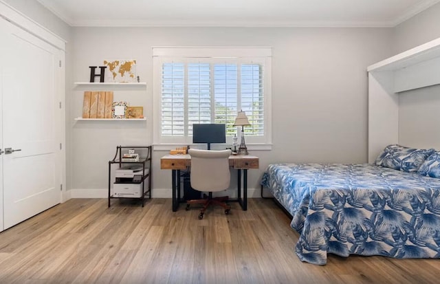 bedroom with wood-type flooring and ornamental molding