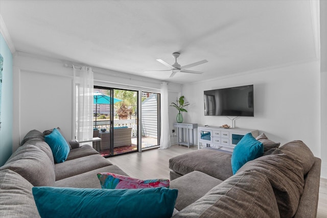 living room with ceiling fan, ornamental molding, and light hardwood / wood-style flooring