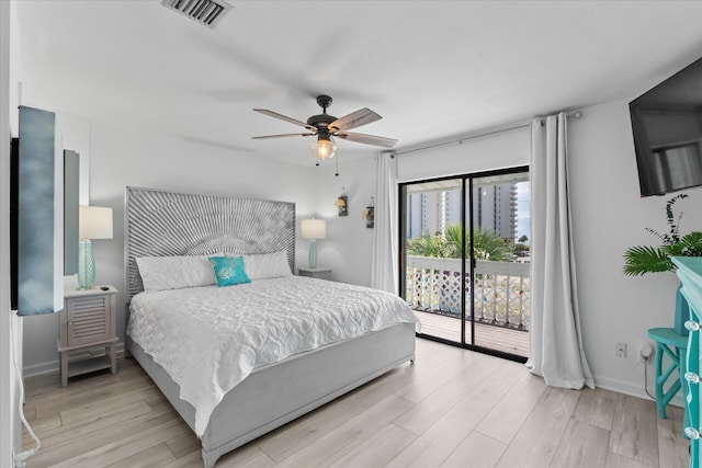 bedroom featuring access to exterior, light hardwood / wood-style floors, and ceiling fan