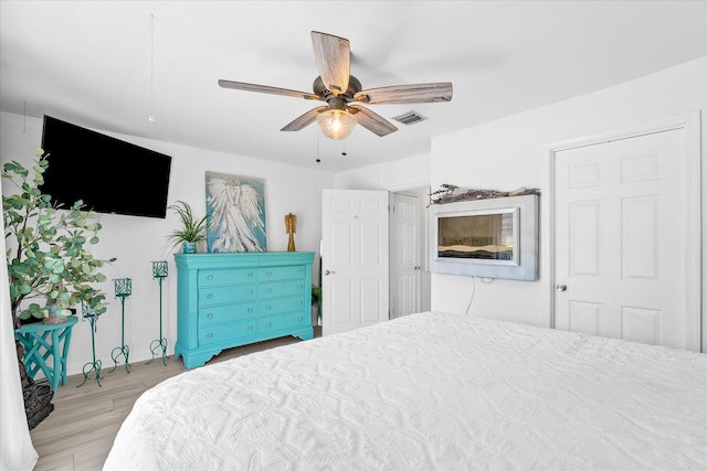 bedroom with ceiling fan and light hardwood / wood-style floors