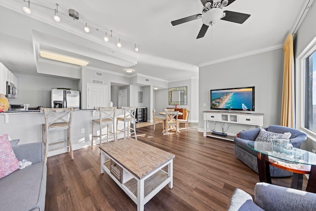 living room with ornamental molding, ceiling fan, and dark wood-type flooring