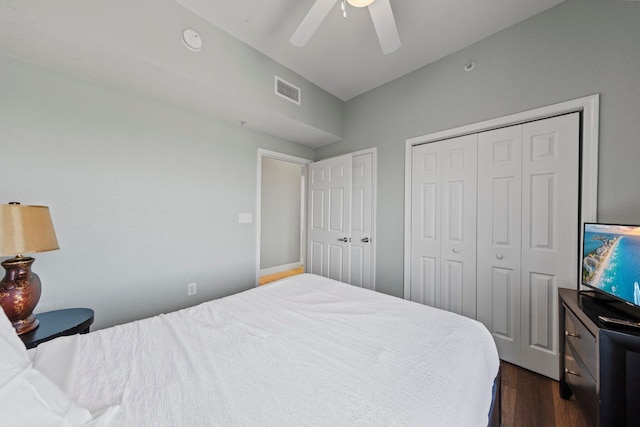 bedroom with dark hardwood / wood-style flooring and ceiling fan