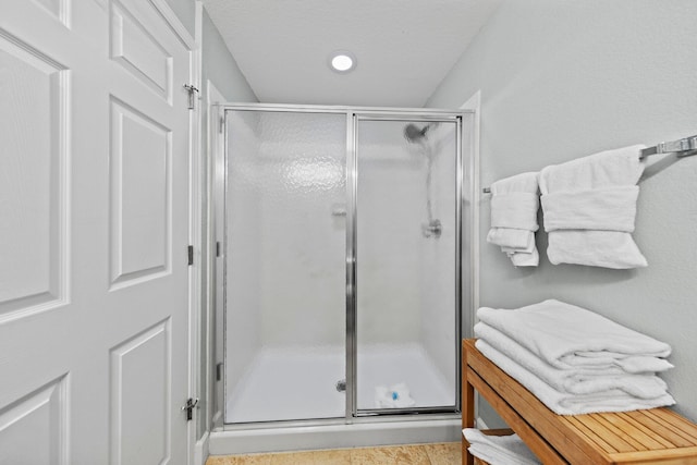 bathroom featuring tile patterned flooring and a shower with door