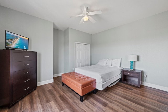 bedroom with dark hardwood / wood-style flooring, a closet, and ceiling fan