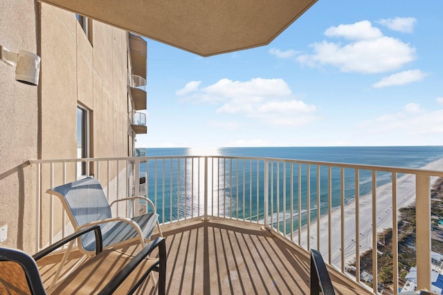 balcony featuring a water view and a beach view